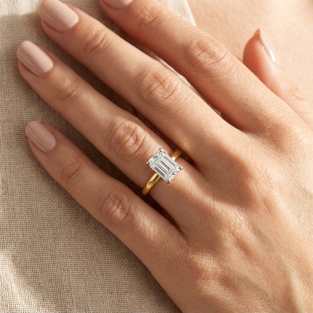 SOL-100EM-0LD Emerald solitaire engagement ring hand-model