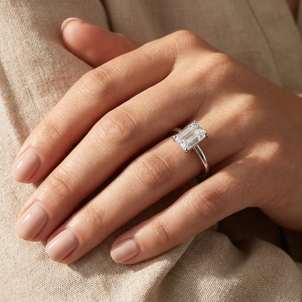 SOL-250EM-0WLD Emerald solitaire engagement ring hand-model