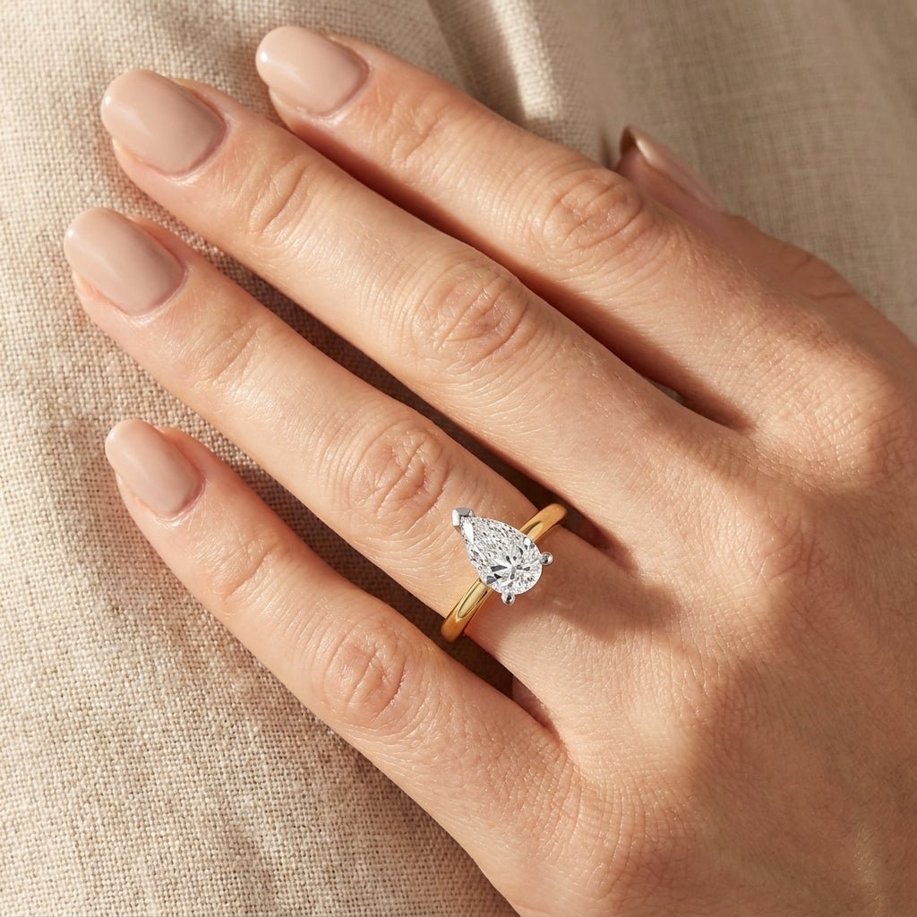 SOL-200PE-0LD Pear solitaire engagement ring hand-model