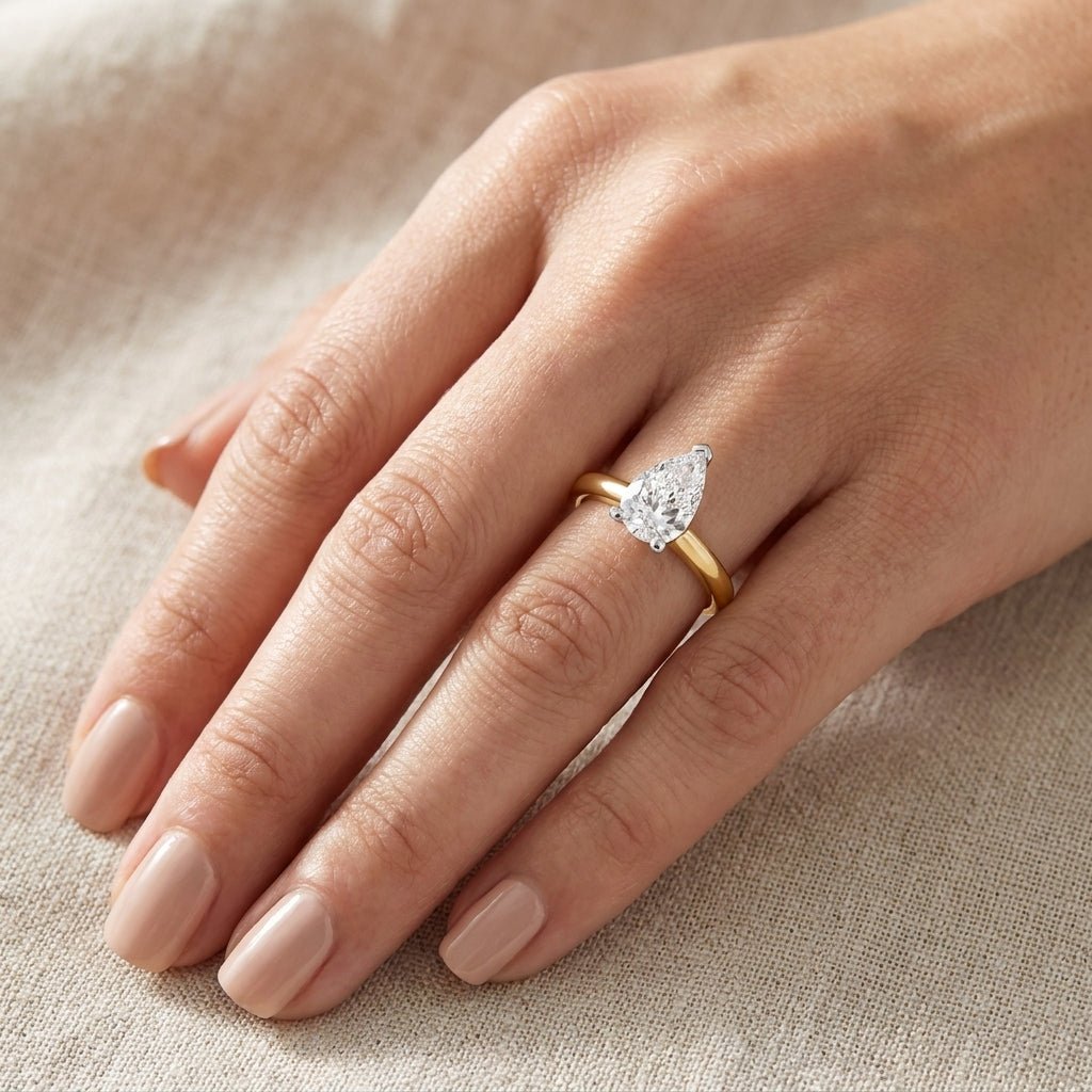 SOL-100PE-0LD Pear solitaire engagement ring hand-model