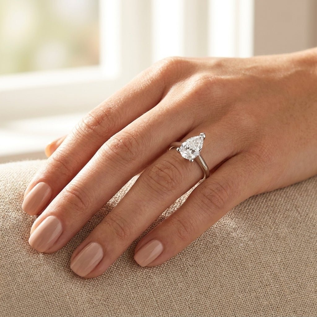 SOL-200PE-0WLD Pear solitaire engagement ring hand-model