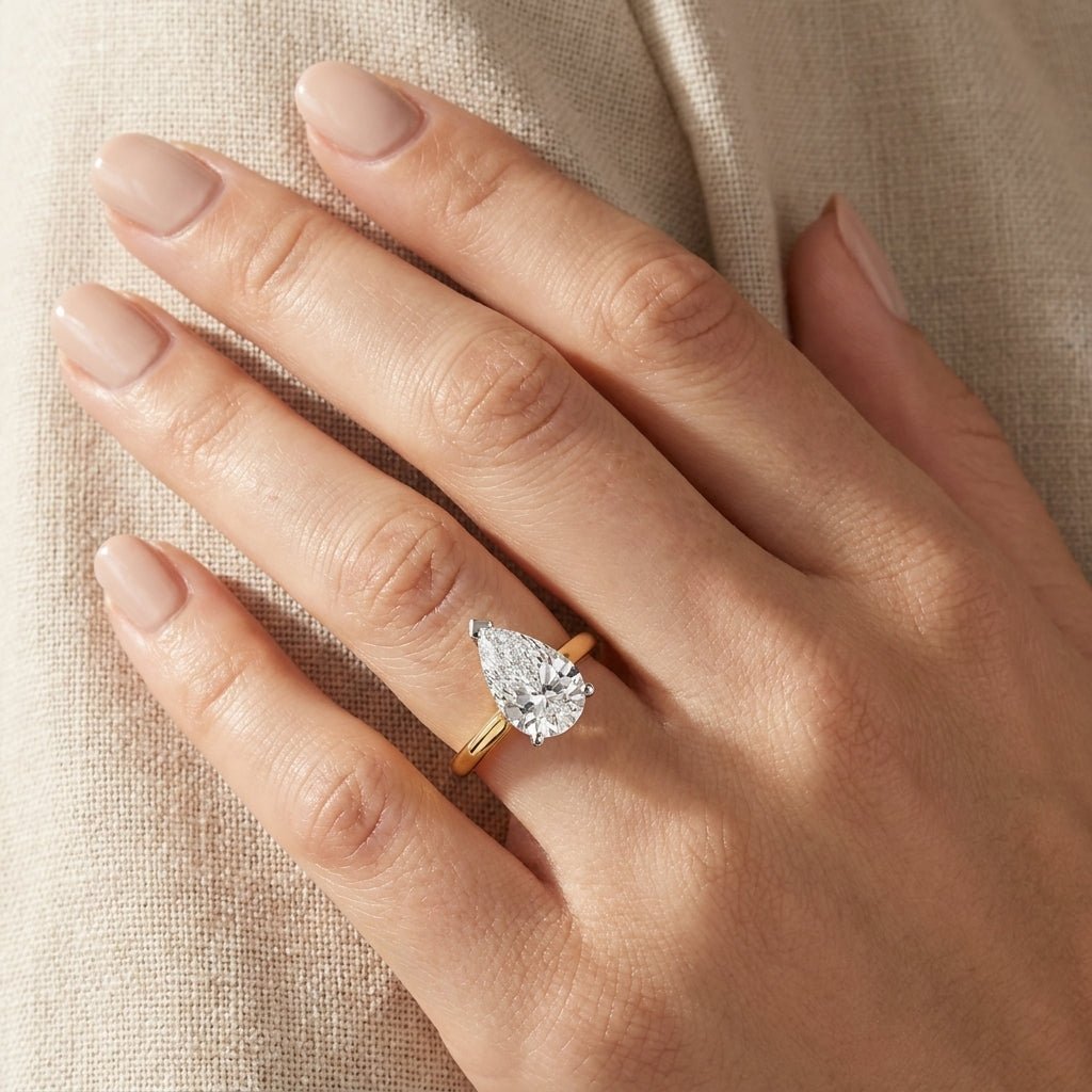 SOL-300PE-0LD Pear solitaire engagement ring hand-model