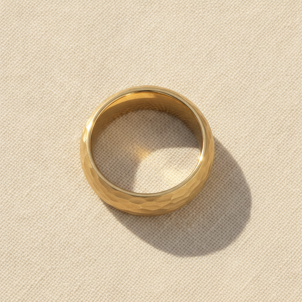 GILDUR gold-plated tungsten wedding band with domed hammered finish macro detail overhead flat lay