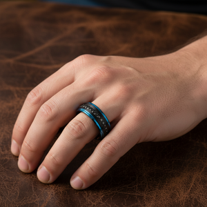 Man wearing ALISO black tungsten with blue edges black CZ eternity ring on ring finger masculine hand