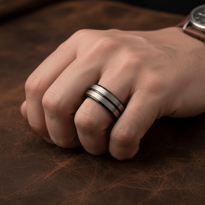 ASHCHIL — Lifestyle photo on hand — men's tungsten wedding ring.