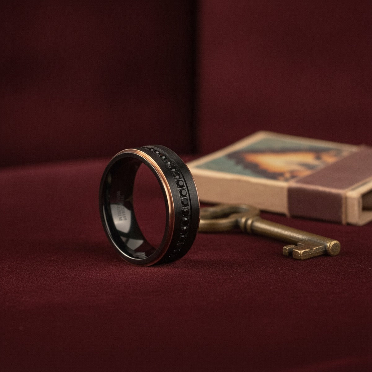 Aydins ASTRO | Black Titanium Ring, Sapphire Stones, Rose Gold Stepped Edges lifestyle scene, speakeasy velvet