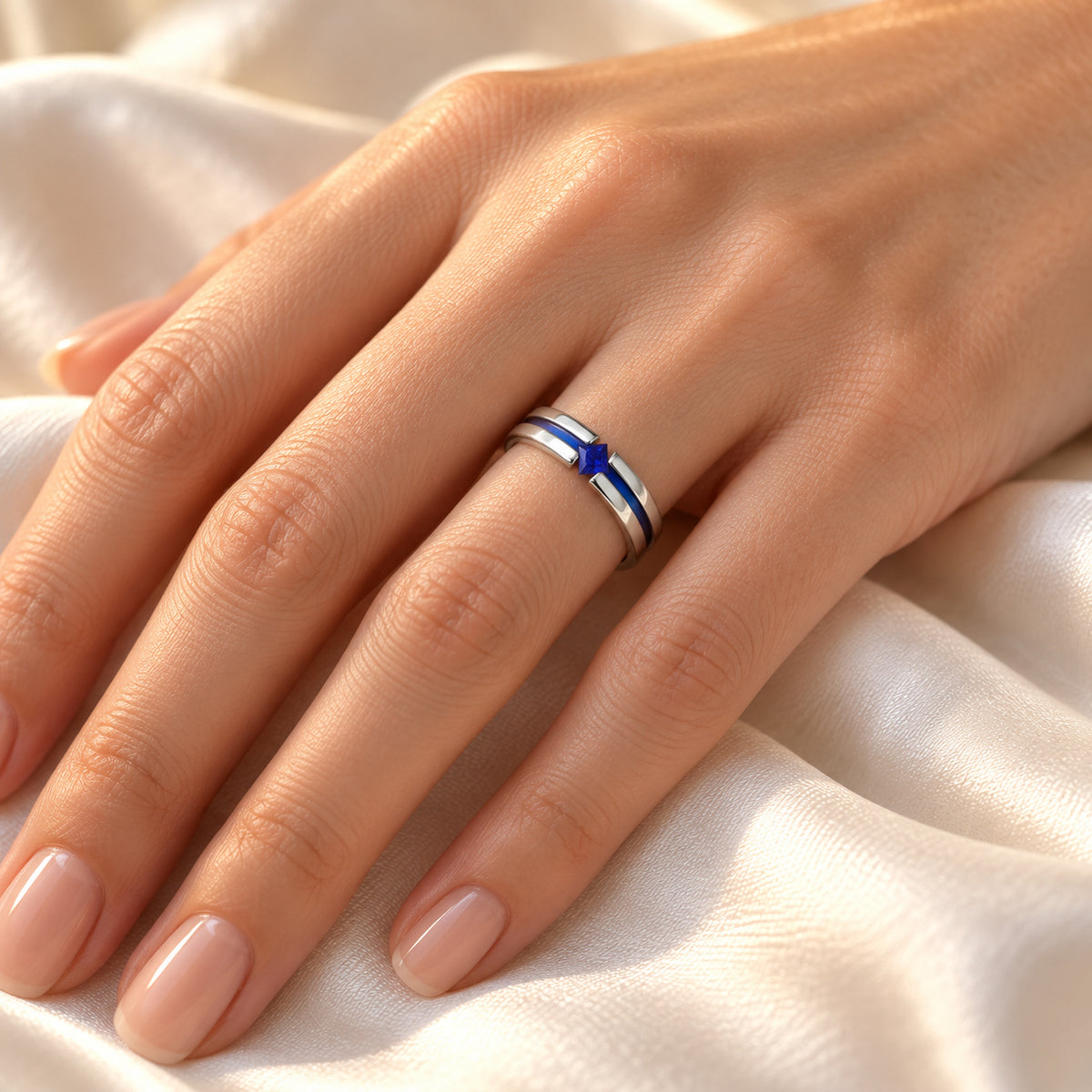 NYMERIA titanium band with blue sapphire and blue stripe, on hand