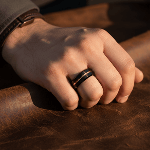 BAIR — Lifestyle photo on hand — men's tungsten wedding ring.
