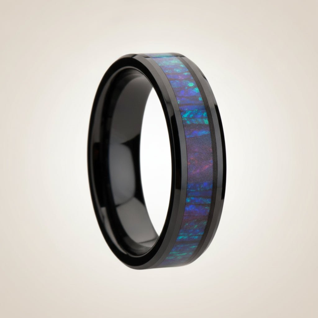 BARRACUDA black ceramic wedding band with blue and purple color-changing opal inlay running around the band and polished beveled edges, studio hero shot