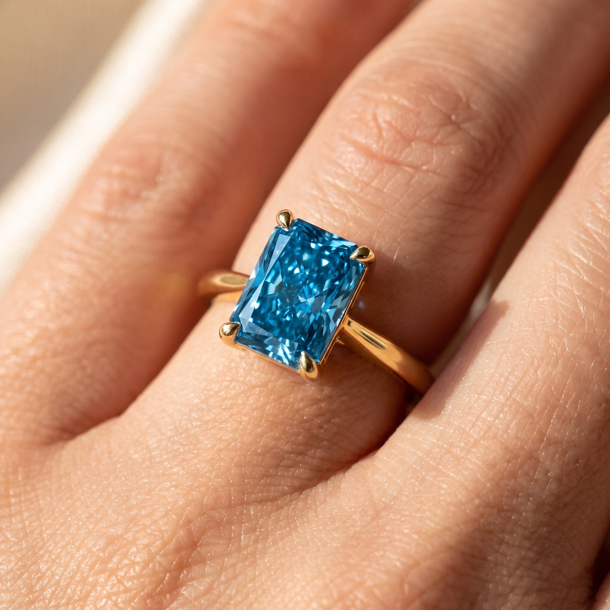 Blue Radiant lab-grown diamond solitaire engagement ring, Yellow Gold, on-finger close-up