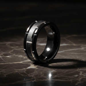 BRICKADE — Luxury 3/4 angle on dark marble — men's tungsten wedding ring.