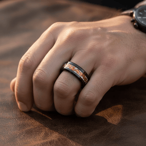 BRONZIUM — Lifestyle photo on hand — men's tungsten wedding ring.