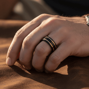 CALLISTO — Lifestyle photo on hand — men's tungsten wedding ring.