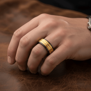 CENTAUR — Lifestyle photo on hand — men's tungsten wedding ring.