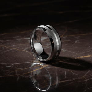 CENTURION — Luxury 3/4 angle on dark marble — men's tungsten wedding ring.