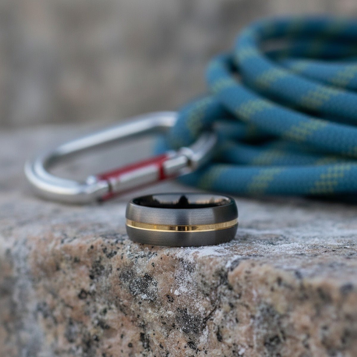 Aydins CHARGOLD | Gunmetal Tungsten Brushed Offset Gold Groove Domed Wedding Ring 8mm lifestyle scene, climbing chalk