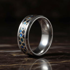 CHAZY — Luxury 3/4 angle on dark marble — men's tungsten wedding ring.
