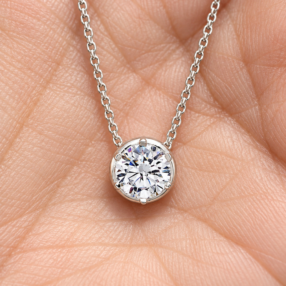 Classic Round Diamond Solitaire Necklace, silver, lab grown diamonds, resting on a hand