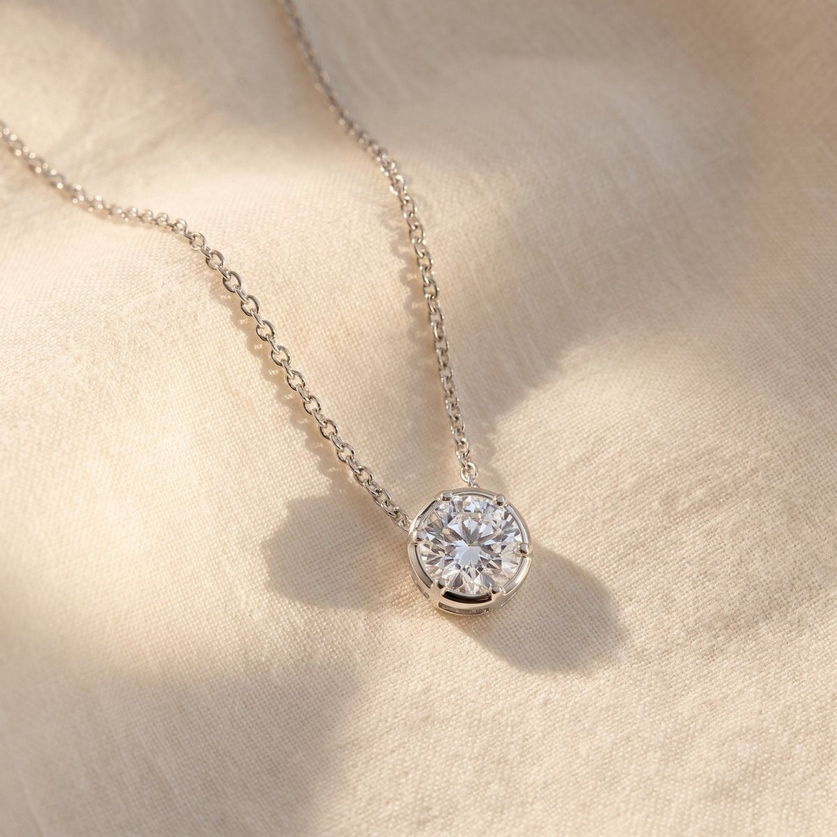 Classic Round Diamond Solitaire Necklace 925 silver lab grown diamond necklace styled flat lay on cream linen