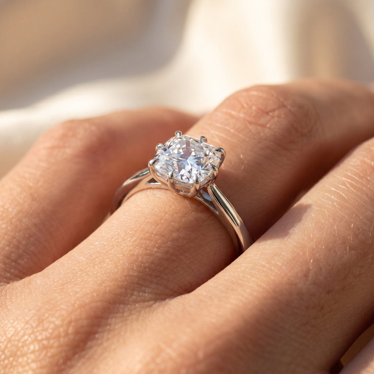 Cushion lab-grown diamond solitaire engagement ring, White Gold, on-finger close-up
