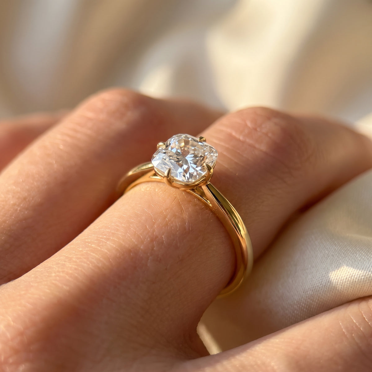 Cushion lab-grown diamond solitaire engagement ring, Yellow Gold, on-finger close-up