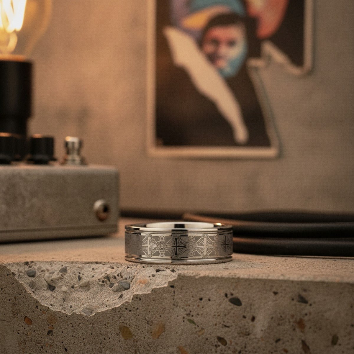 Aydins DEACON | Silver Tungsten Ring, Laser Engraved Celtic Crosses, Flat lifestyle scene, punk basement
