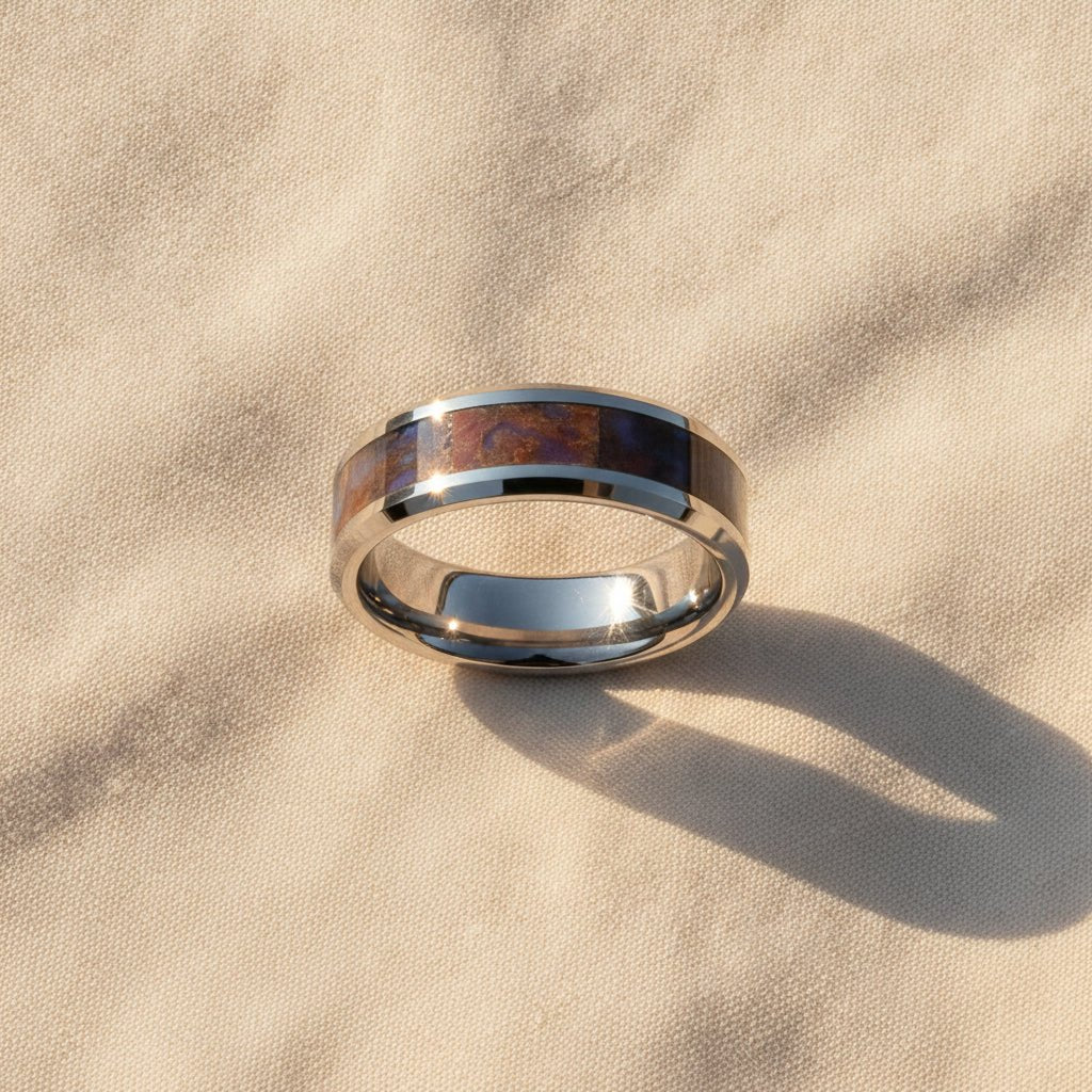 DEVONIAN silver tungsten carbide ring with blue dinosaur bone inlay running around the band and polished beveled edges macro detail overhead flat lay