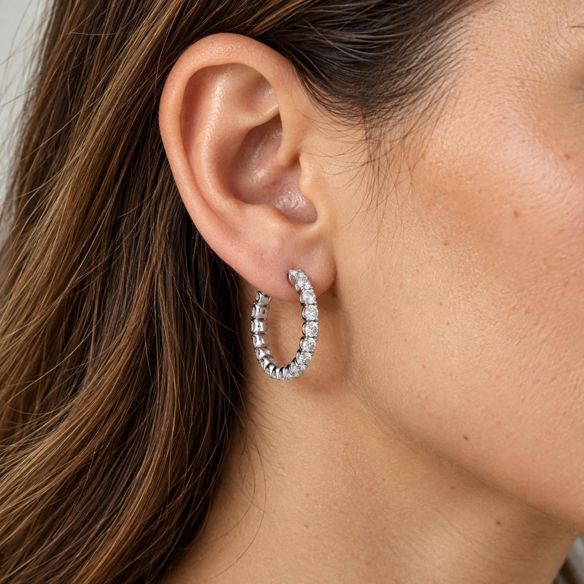 Lab-grown diamond hoop earrings in sterling silver, worn on the ear, lifestyle photo