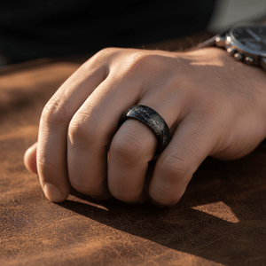 DOMINATOR — Lifestyle photo on hand — men's tungsten wedding ring.