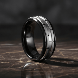 DUALITY — Luxury 3/4 angle on dark marble — men's tungsten wedding ring.