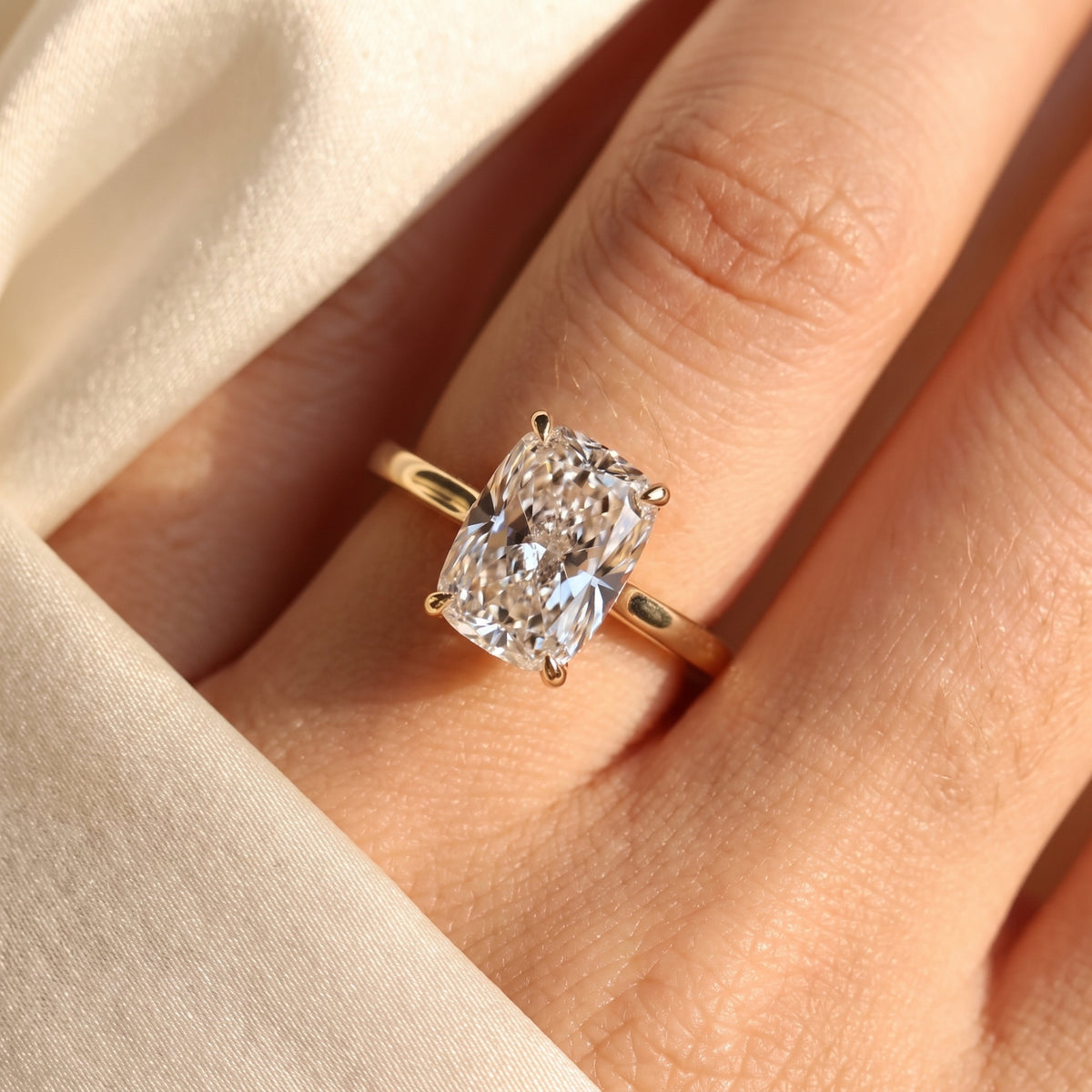Elongated Cushion lab-grown diamond solitaire engagement ring, Yellow Gold, on-finger close-up