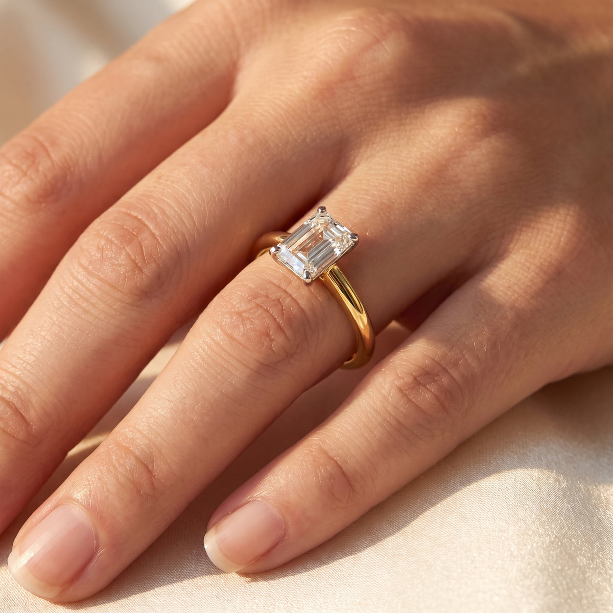 Emerald lab-grown diamond solitaire engagement ring, Yellow Gold, on-finger close-up