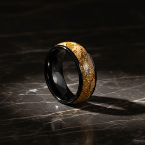 ERMIS — Luxury 3/4 angle on dark marble — men's tungsten wedding ring.
