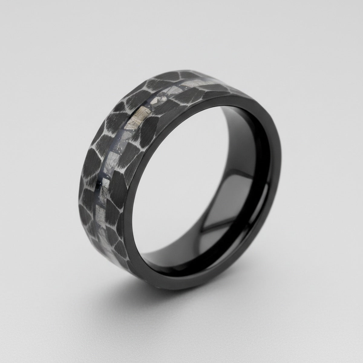 FISSURE black tungsten ring at 45 degree perspective showing hammered finish and meteorite inlay