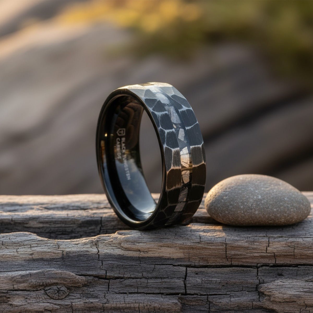 FISSURE black tungsten ring on weathered wood with soft natural light