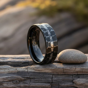 FISSURE black tungsten ring on weathered wood with soft natural light