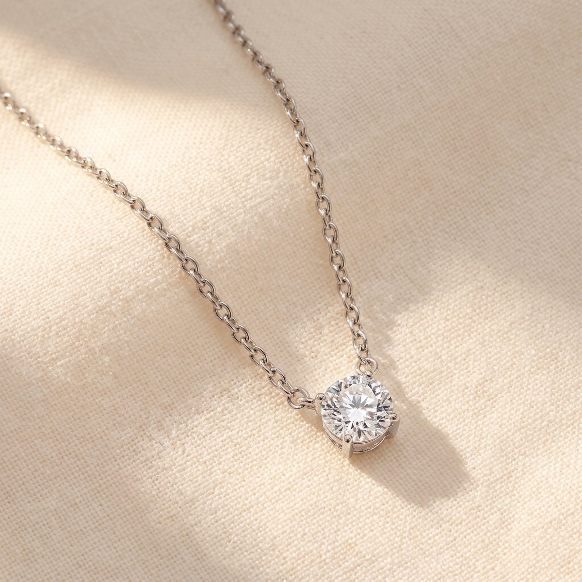 Four Prong Round Diamond Solitaire Necklace 925 silver lab grown diamond necklace styled flat lay on cream linen