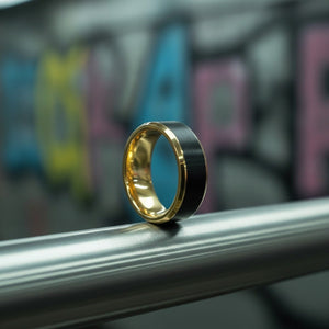 Aydins GASTON | Gold Tungsten Wedding Band Brushed Black Center lifestyle scene, underground train