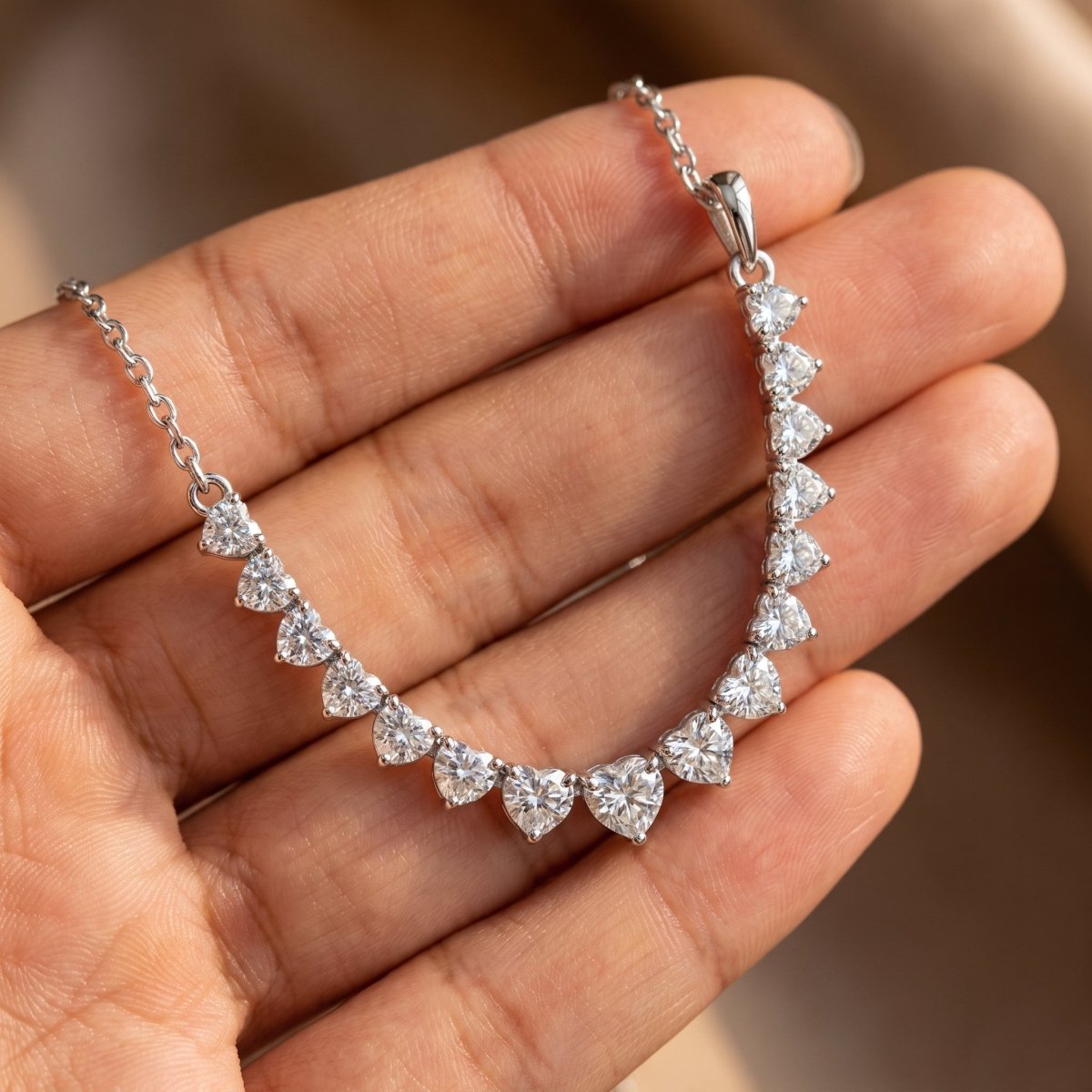 Graduated Diamond Necklace With Chain 925 silver lab grown diamond necklace held in hand lifestyle close-up photo