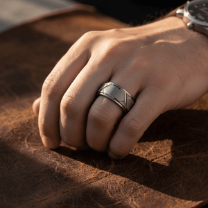 GRAPHIZOID — Lifestyle photo on hand — men's tungsten wedding ring.