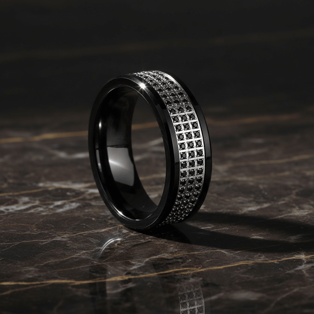 GRAVEL — Luxury 3/4 angle on dark marble — men's tungsten wedding ring.