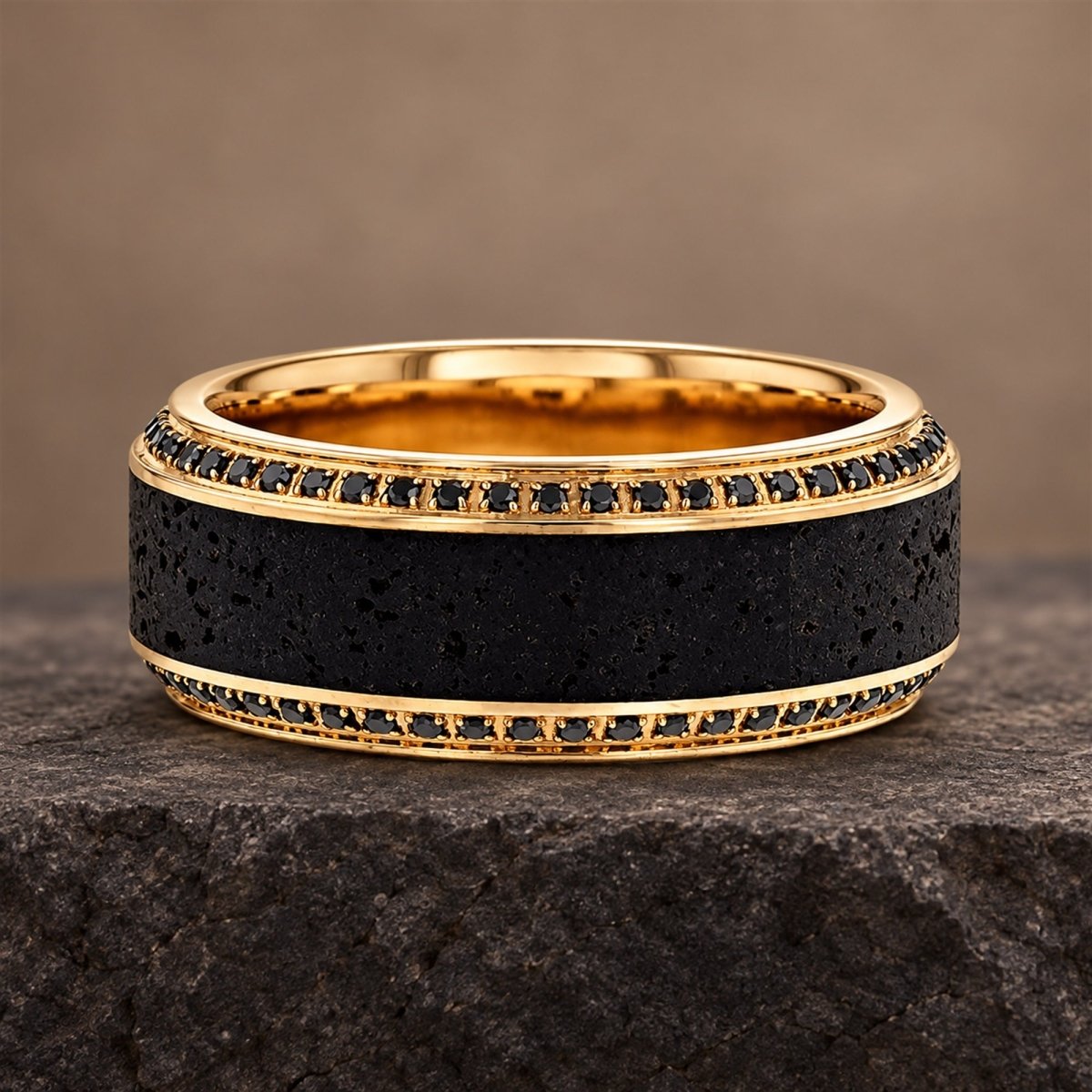 HYPERION 10mm lava and black diamond wedding band in yellow gold, front view on a stone ledge