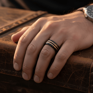 JAUCA — Lifestyle photo on hand — men's tungsten wedding ring.