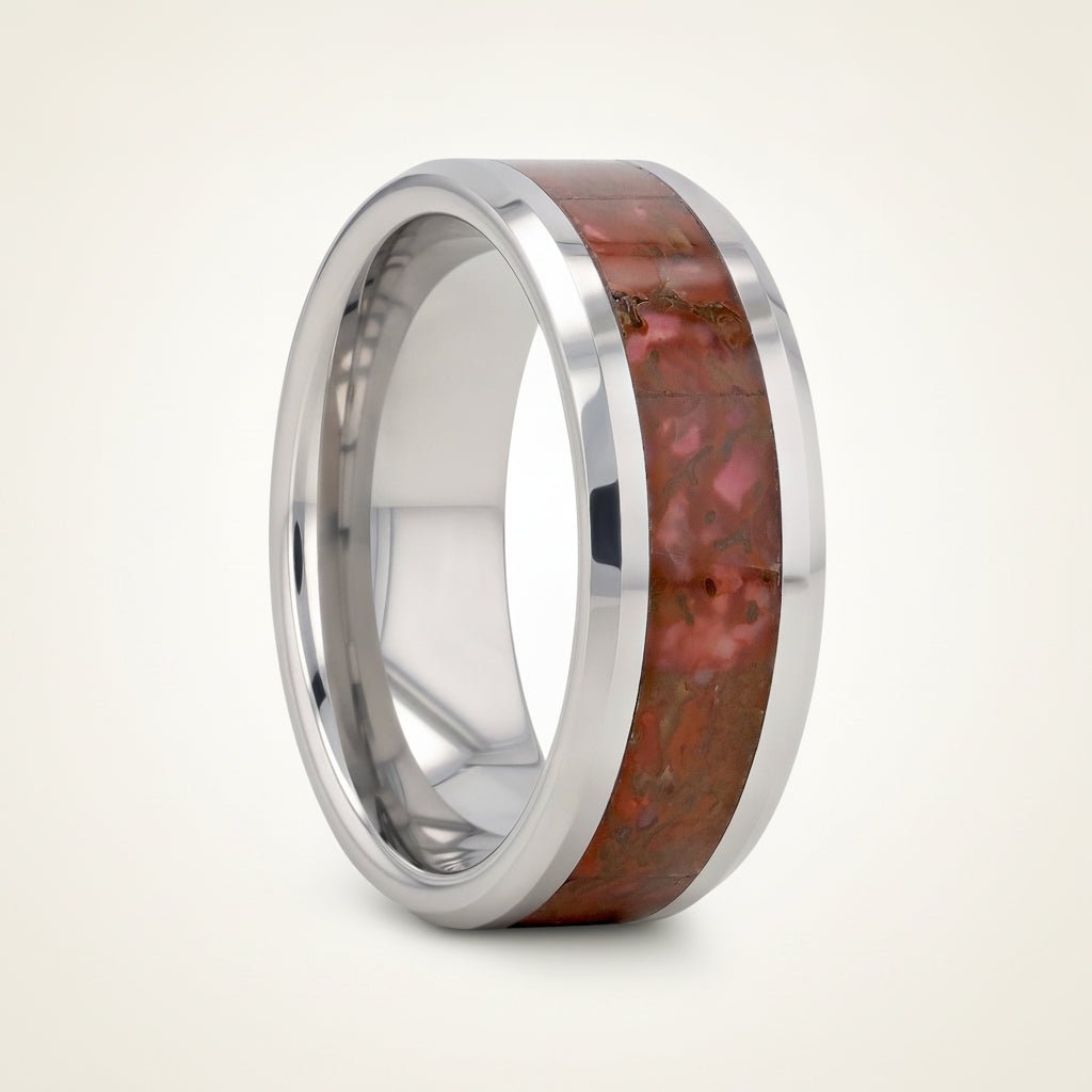 JURASSIC silver tungsten carbide ring with red dinosaur bone inlay running around the band and polished beveled edges, studio hero shot