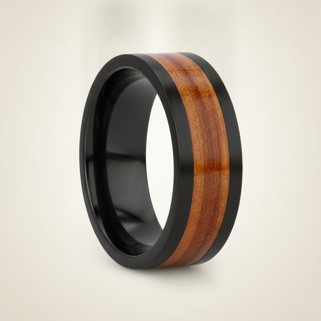 KALANI flat black tungsten carbide wedding band with koa wood inlay running around the band and polished edges, studio hero shot