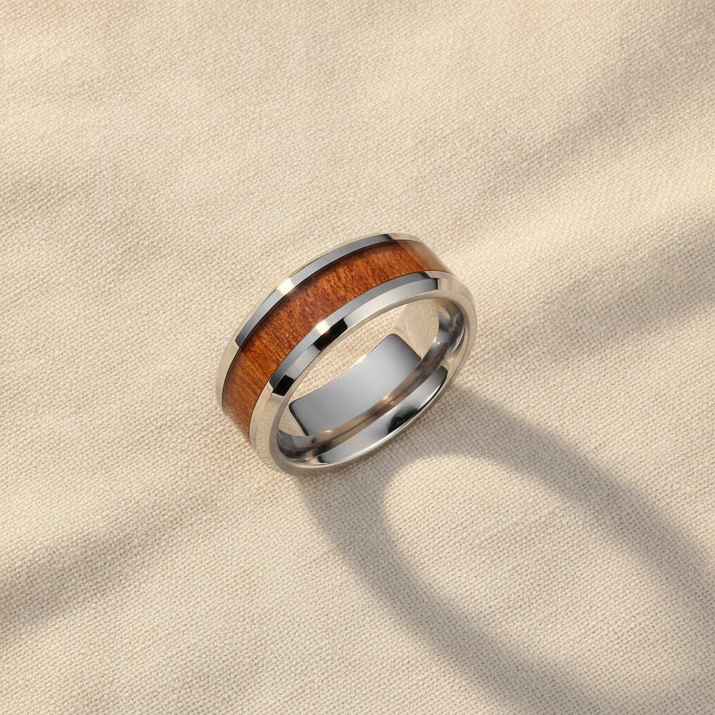 KODIAK silver tungsten carbide wedding band with rosewood inlay running around the band and polished edges macro detail overhead flat lay