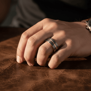 KORAI — Lifestyle photo on hand — men's tungsten wedding ring.