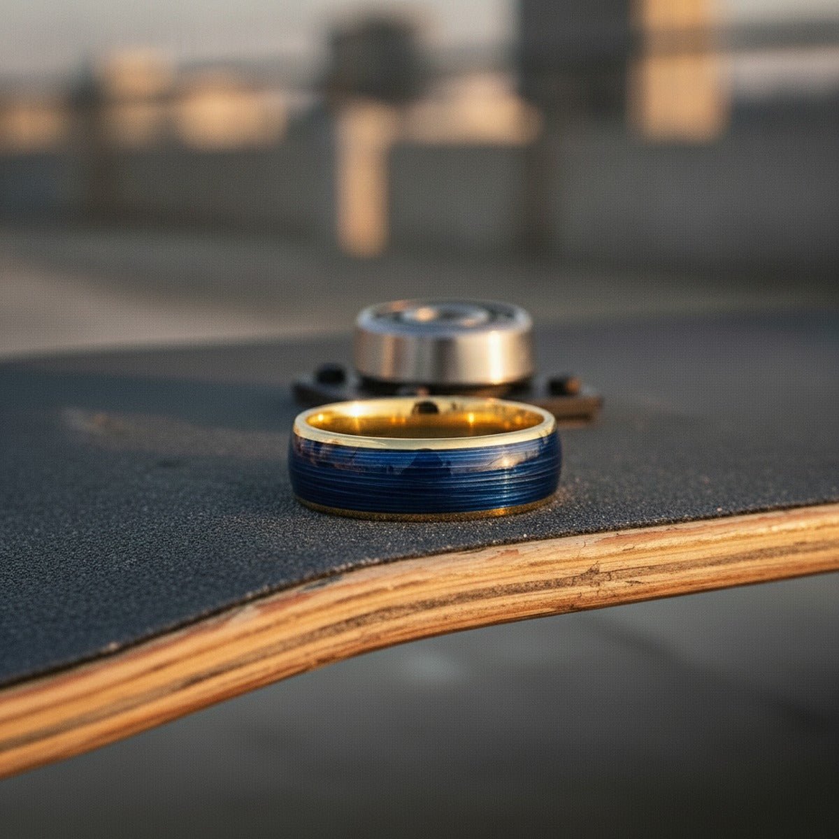 Aydins LEHRI | Polished Yellow Gold Tungsten Blue Wire Inlay Domed Wedding Ring — 8mm lifestyle scene, skateboard griptape
