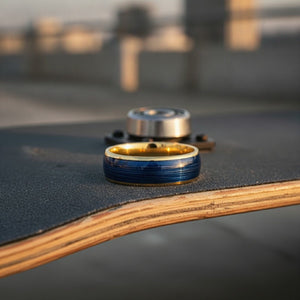 Aydins LEHRI | Polished Yellow Gold Tungsten Blue Wire Inlay Domed Wedding Ring — 8mm lifestyle scene, skateboard griptape