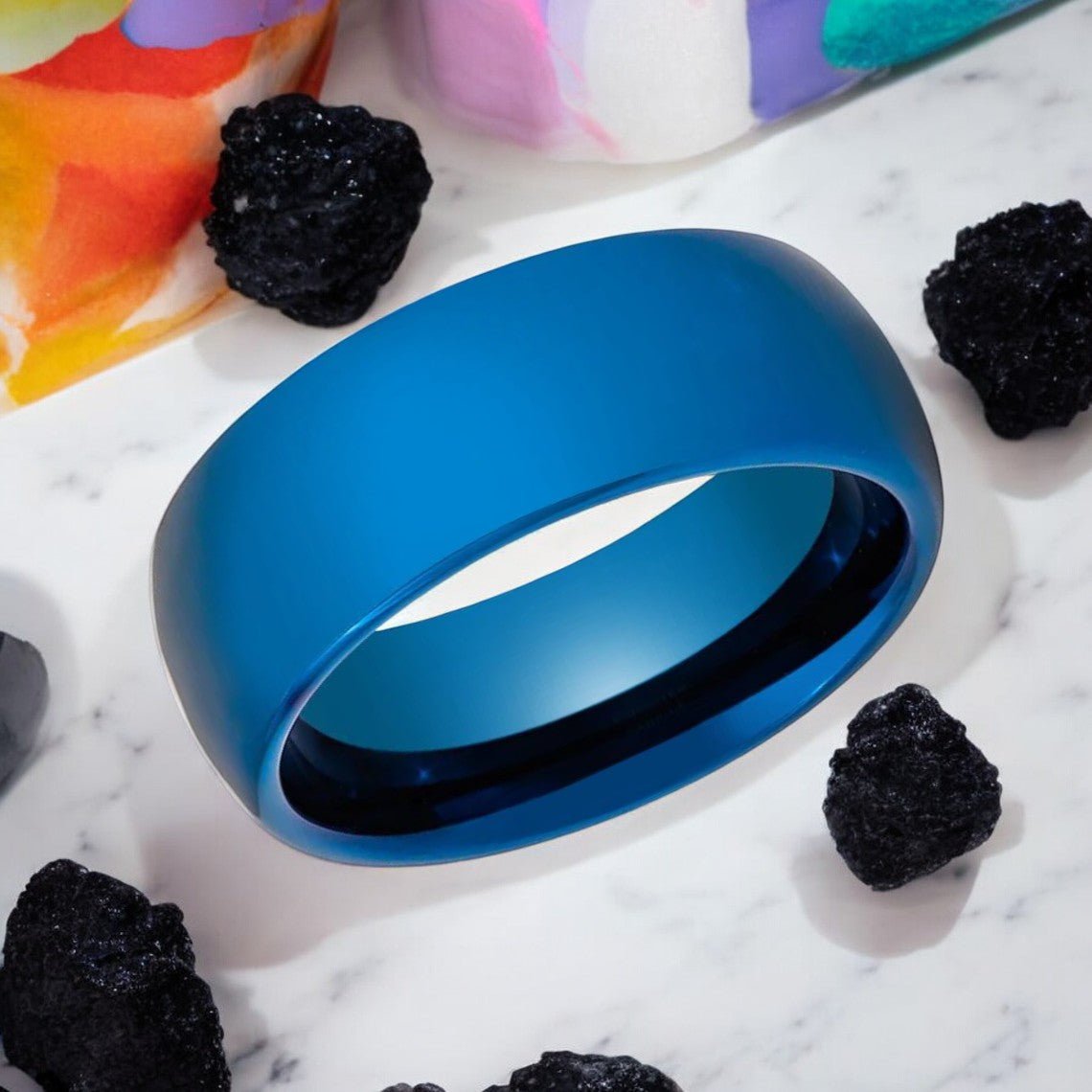 Angled display of polished electric blue tungsten band